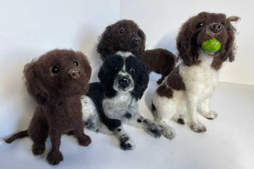 Needle-felted dog portraits side by side